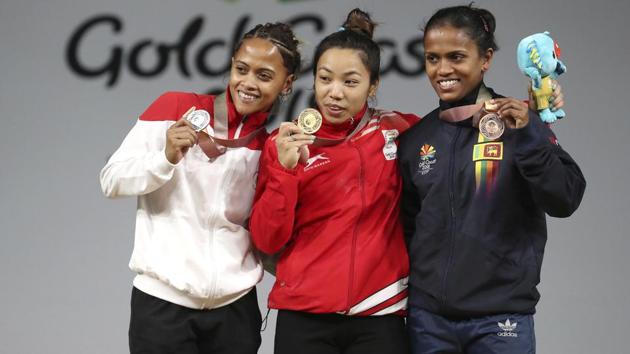 Saikhom Mirabai Chanu (C) stands with silver medallist of Marie Hanitra Ranaivosoa (L) and bronze medallist Dinusha Gomes after the event. (AP) Saikhom Mirabai Chanu (C) stands with silver medallist of Marie Hanitra Ranaivosoa (L) and bronze medallist Dinusha Gomes after the event. (AP)