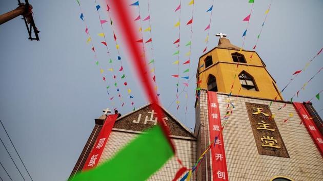 On the recent Good Friday celebrations displays of faith were ubiquitous. Villagers poured into the streets to attend afternoon mass at the official church, whose spire is topped with a large cross that glints in the sunlight. Bright red banners with religious slogans, including the Chinese characters for ‘Emmanuel’, meaning God is with us, adorned many homes. (Damir Sagolj / REUTERS)