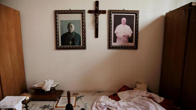 Portraits of Pope Francis and Julius Jia Zhiguo, Vatican-backed underground bishop of Zhengding diocese, are seen in the state-sanctioned church. Relations among rival churches are cordial, but villagers feel that local schisms could arise from renewed attempts to push together the state-sanctioned church which claims independence from the Vatican and underground ones loyal to Pope Francis. (Damir Sagolj / REUTERS)