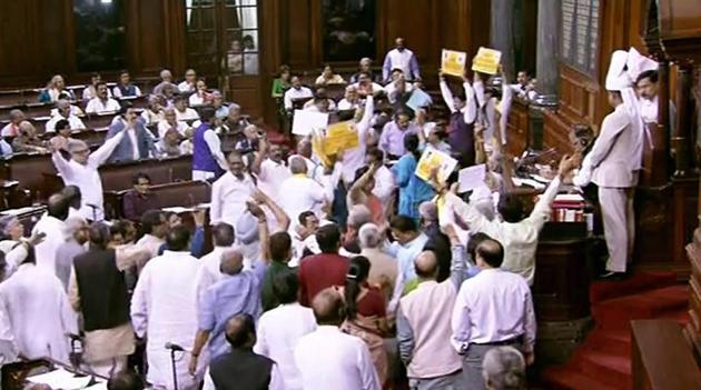 Opposition members protest infront of Rajya Sabha chairperson M Venkaiah Naidu during the on-going budget session of Rajya Sabha, at Parliament House in New Delhi on Wednesday.(PTI Photo)