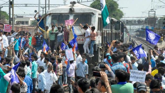 Protesters stop a train during Bharat bandh, Moradabad, April 4, 2018 (PTI) Protesters stop a train during Bharat bandh, Moradabad, April 4, 2018 (PTI)
