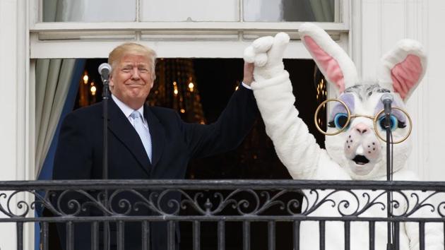 US President Donald Trump and the Easter Bunny stand together on the Truman Balcony at the White House in Washington during the annual White House Easter Egg Roll. (Carolyn Kaster / AP)