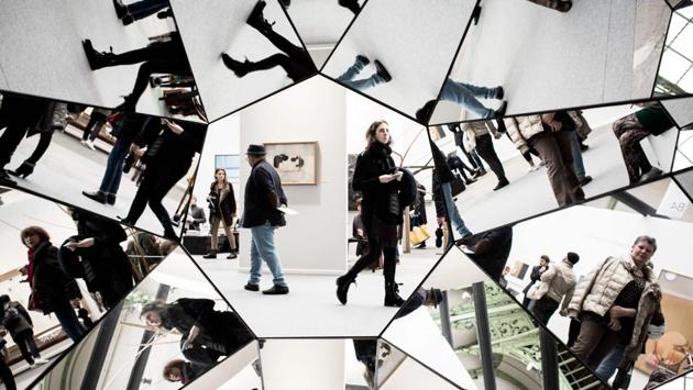 Visitors are reflected in an artwork by Swiss artist Simon Deppierraz at the Paris Art Fair in Paris, France. (Philippe Lopez / AFP)