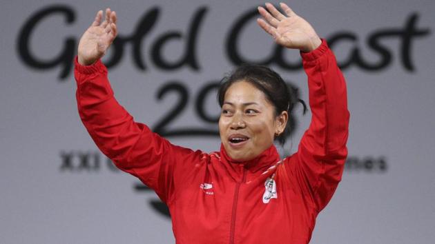 Sanjita Chanu waves during the medal ceremony after winning gold in the women’s 53 kg weightlifting. (REUTERS)