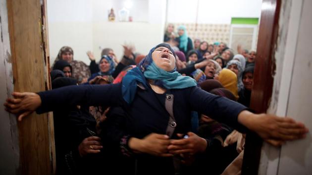 Mourners hold back a relative of Palestinian Hamdan Abu Amshah, who was killed along Israel border with Gaza, during his funeral in Beit Hanoun town, in the northern Gaza Strip. (Suhaib Salem / REUTERS)