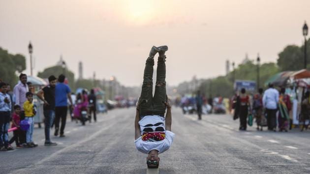 Passers-by look on as Mohammed Al Hendi does a headstand at Raj Path. The group found regional fame with its appearances on Arabs Got Talent, a variant of the American talent reality show and is now based out of Jordan after difficulties with Palestinian border closures made representing their country in parkour and free running tournaments difficult. (Burhaan Kinu / HT Photo) Passers-by look on as Mohammed Al Hendi does a headstand at Raj Path. The group found regional fame with its appearances on Arabs Got Talent, a variant of the American talent reality show and is now based out of Jordan after difficulties with Palestinian border closures made representing their country in parkour and free running tournaments difficult. (Burhaan Kinu / HT Photo)