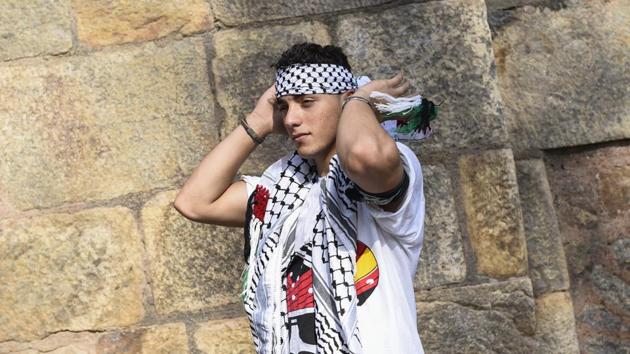 Al Hendi ties a chequered black and white keffiyeh, a symbol of Palestinian nationalism. Through their appearances in international contests, Free Run Gaza aim to further awareness of the Palestinian cause through non-violent means and hoped to share their message of pushing on in the face of adversity during this visit to India. (Burhaan Kinu / HT Photo) Al Hendi ties a chequered black and white keffiyeh, a symbol of Palestinian nationalism. Through their appearances in international contests, Free Run Gaza aim to further awareness of the Palestinian cause through non-violent means and hoped to share their message of pushing on in the face of adversity during this visit to India. (Burhaan Kinu / HT Photo)