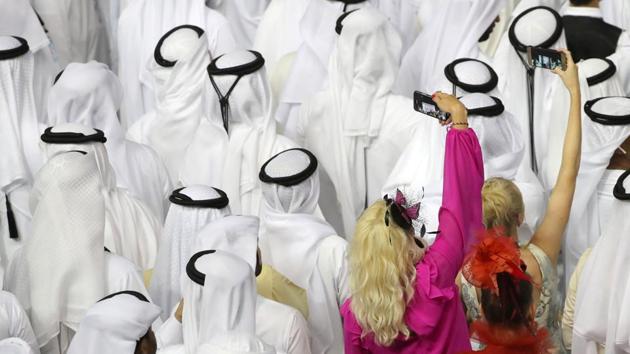 Fans attend the trophy presentation in the Meydan Racecourse in Dubai, United Arab Emirates. (Karim Sahib / AFP)