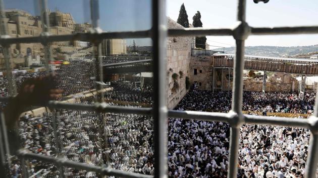 Jewish priests and religious men wearing “Talit” (prayer shawls) take part in the Cohanim prayer during the Passover holiday at the Western Wall in the Old City of Jerusalem. Thousands of Jews make the pilgrimage to Jerusalem during the eight-day Pesach holiday, which commemorates the Israelites' exodus from slavery in Egypt. (Menahem Kahana / AFP)