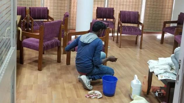 A worker polishing furniture in room number 19 on the seventh floor of the secretariat. (HT Photo) A worker polishing furniture in room number 19 on the seventh floor of the secretariat. (HT Photo)