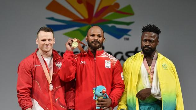 Gold medallist, India's Sathish Kumar Sivalingam (C) with silver medallist, England's Jack Oliver, and bronze medallist, Australia's Francois Etoundi, during the medal ceremony of the men's 77kg weightlifting category during the 2018 Commonwealth Games in Gold Coast, on Saturday. (PTI)