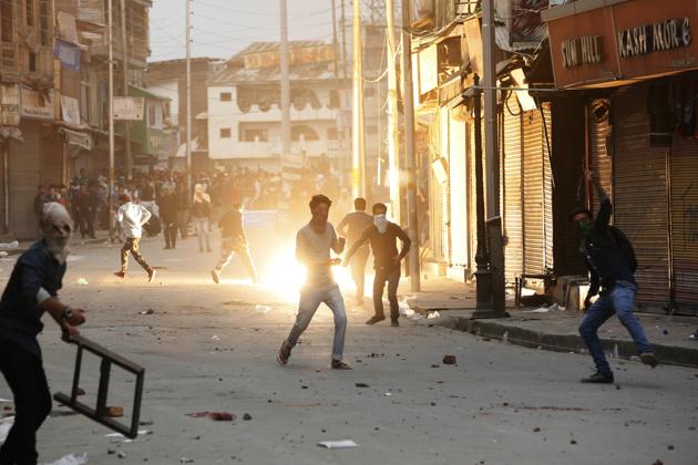 Kashmiri students throw stones at policemen as a tear gas shell explodes behind them during a protest in Srinagar on April 5, 2018.(AP File Photo) Kashmiri students throw stones at policemen as a tear gas shell explodes behind them during a protest in Srinagar on April 5, 2018.(AP File Photo)