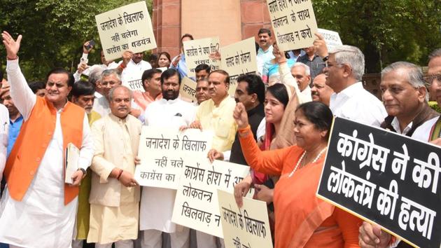 In a rare sight, ministers protested in front of the fabled Gandhi statue in the Parliament complex against the non-functioning of the legislature on the last working day. Ministers Ananth Kumar, Ram Vilas Paswan, S S Ahluwalia and Anand Manoj Sinhawere among protestors. The Congress hit back soon after, moving a privilege motion against Kumar for deliberately naming the Congress. (Arvind Yadav / HT Photo) 