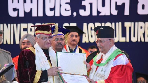 Nepalese Prime Minister KP Sharma Oli (R) receives an honorary degree of Doctor of Science from Pant University of Agriculture and Technology chancellor KK Paul in Pantnagar on Sunday.(HT Photo)