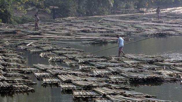 Labourers push heaps of bamboo on a river to be sold at a floating market in Chakmaghat, Tripura. (AFP file photo) Labourers push heaps of bamboo on a river to be sold at a floating market in Chakmaghat, Tripura. (AFP file photo)
