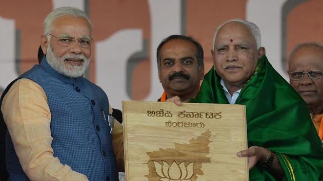 Prime Minister Narendra Modi (left) presents a momento to Karnataka state BJP leader BS Yeddyurappa during a gathering in Bangalore on February 4. (AFP file photo) Prime Minister Narendra Modi (left) presents a momento to Karnataka state BJP leader BS Yeddyurappa during a gathering in Bangalore on February 4. (AFP file photo)