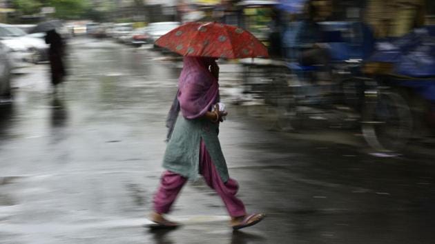 A woman walks in the rain under an umbrella through the lanes of Jangpura. Delhi woke up to a light downpour preceded by a thunderstorm on Monday morning, with the temperature dipping to 24 degree Celsius. (Anushree Fadnavis / HT Photo) A woman walks in the rain under an umbrella through the lanes of Jangpura. Delhi woke up to a light downpour preceded by a thunderstorm on Monday morning, with the temperature dipping to 24 degree Celsius. (Anushree Fadnavis / HT Photo)