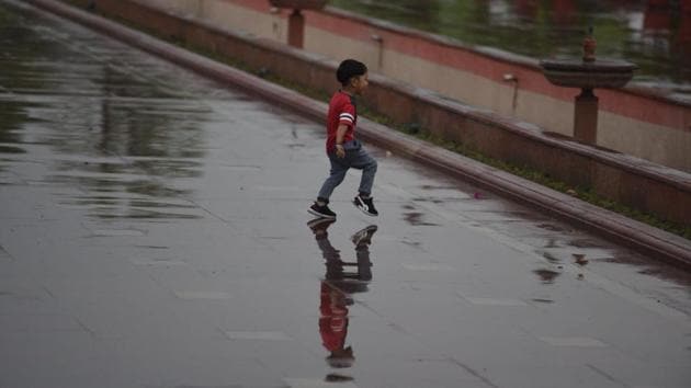 A boy enjoys this change of the weather at Rajpath. The effect of Sunday’s rainfall in Srinagar was visible in the various parts of the national capital. According to the Indian Meteorological Department’s forecast, the day will be overcast with light rain expected later on. (Raj K Raj / HT Photo) A boy enjoys this change of the weather at Rajpath. The effect of Sunday’s rainfall in Srinagar was visible in the various parts of the national capital. According to the Indian Meteorological Department’s forecast, the day will be overcast with light rain expected later on. (Raj K Raj / HT Photo)