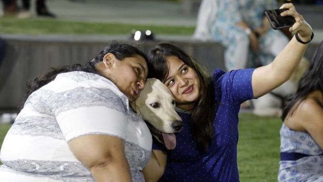 Pet-lovers taking a selfie and capturing the moment at the PetYo festival Pune 2018 at Amanora Club House in Pune on April 8. (RAHUL RAUT/HT PHOTO)