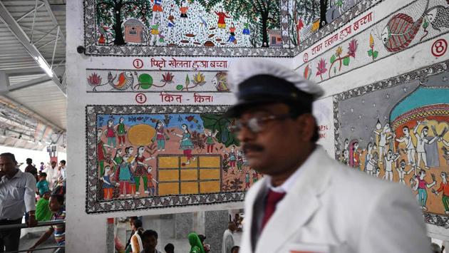 Indian Railways station master Jagdamba Prasad walks past Mithila wall paintings inside the Madhubani railway station. Madhubani art, traditionally famous for its prevalence on the walls and floors of rustic homes, today boasts of the coveted GI (Geographical Indication) tag and is painted on cloth, canvas and paper. (Prakash Singh / AFP) Indian Railways station master Jagdamba Prasad walks past Mithila wall paintings inside the Madhubani railway station. Madhubani art, traditionally famous for its prevalence on the walls and floors of rustic homes, today boasts of the coveted GI (Geographical Indication) tag and is painted on cloth, canvas and paper. (Prakash Singh / AFP)