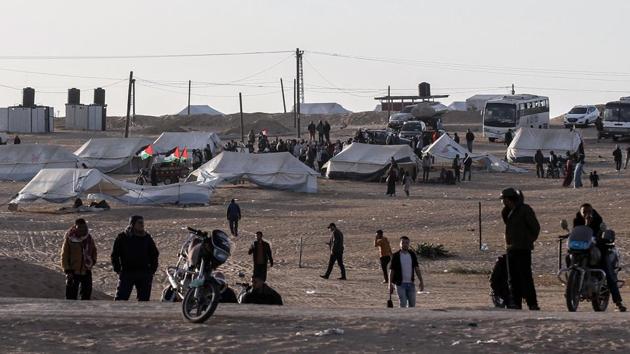 Organizers portray those affiliated with militant groups as fellow protesters who left weapons and faction insignia at home. Thousands, including families with children, have flocked to the Khuzaa encampment, where patriotic songs play over loudspeakers. Equipped with portable toilets, floodlights and internet service, earthen berms between the border and the camp provide additional protection. Ambulances are on stand-by to ferry the wounded. (Said Khatib / AFP) Organizers portray those affiliated with militant groups as fellow protesters who left weapons and faction insignia at home. Thousands, including families with children, have flocked to the Khuzaa encampment, where patriotic songs play over loudspeakers. Equipped with portable toilets, floodlights and internet service, earthen berms between the border and the camp provide additional protection. Ambulances are on stand-by to ferry the wounded. (Said Khatib / AFP)