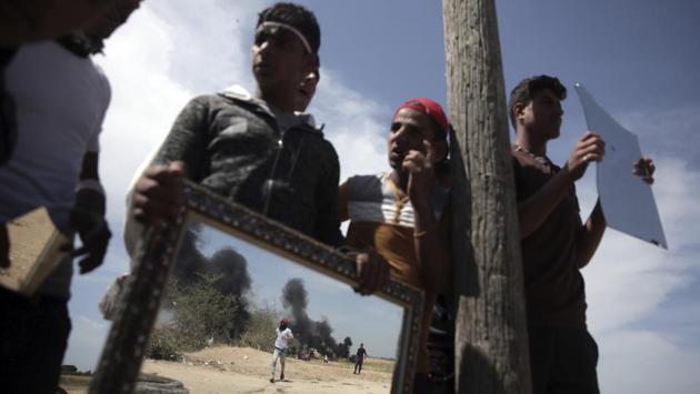 Protesters use mirrors to blind Israeli soldiers during the protest. For Hamas, this is perhaps the last chance to break the blockade enforced by Israel and Egypt since seizing power in 2007. The blockade has devastated Gaza’s economy, making entry and exit virtually impossible, and left residents with just a few hours of electricity a day. Tap water is undrinkable and the Mediterranean coastline has been polluted with untreated waste. (Khalil Hamra / AP) Protesters use mirrors to blind Israeli soldiers during the protest. For Hamas, this is perhaps the last chance to break the blockade enforced by Israel and Egypt since seizing power in 2007. The blockade has devastated Gaza’s economy, making entry and exit virtually impossible, and left residents with just a few hours of electricity a day. Tap water is undrinkable and the Mediterranean coastline has been polluted with untreated waste. (Khalil Hamra / AP)