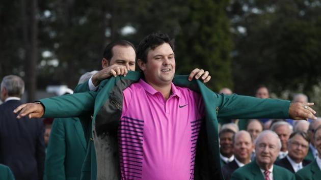 Sergio Garcia of Spain (rear), last year's Masters' champion, helps put the Green Jacket on 2018 Augusta Masters winner Patrick Reed following the final round’s play at the Augusta National Golf Club in Georgia on Sunday.(REUTERS)