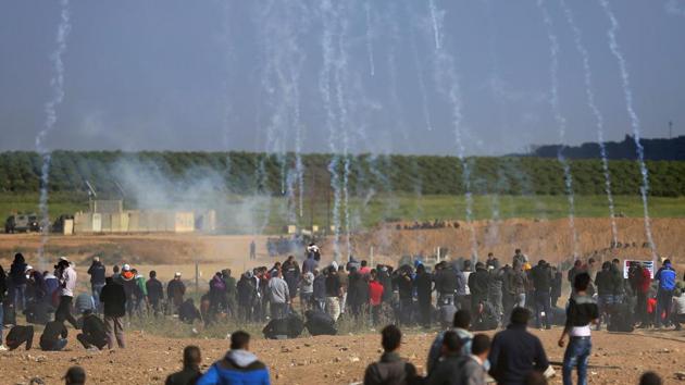 Tear gas canisters fired by Israeli forces rain down on Palestinian protesters. Israel’s defense minister said that the military will not change its response to the Hamas-led mass protests. Thirty one Palestinians have been killed since March 30 -- the first day of what Hamas said will be six weeks of intermittent protests against a stifling blockade of the territory. (Khalil Hamra / AP) Tear gas canisters fired by Israeli forces rain down on Palestinian protesters. Israel’s defense minister said that the military will not change its response to the Hamas-led mass protests. Thirty one Palestinians have been killed since March 30 -- the first day of what Hamas said will be six weeks of intermittent protests against a stifling blockade of the territory. (Khalil Hamra / AP)