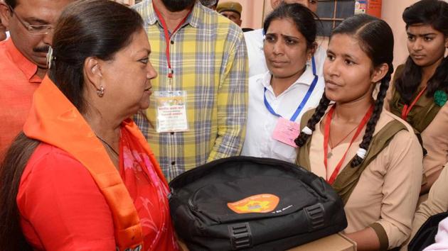 Chief minister Vasundhara Raje presents laptop to meritorious girls at a programme in Sikar on Monday.(HT PHOTO)
