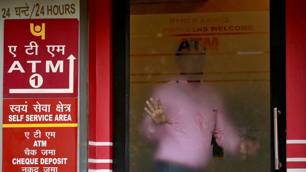A man leaves an automated teller machine (ATM) facility of Punjab National Bank (PNB) in New Delhi. (Reuters File Photo) A man leaves an automated teller machine (ATM) facility of Punjab National Bank (PNB) in New Delhi. (Reuters File Photo)