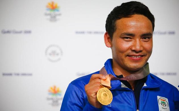 India's Jitu Rai celebrates winning the gold medal on the podium following the men's 10m air pistol shooting final during the 2018 Gold Coast Commonwealth Games at the Belmont Shooting Complex in Brisbane on April 9, 2018.(AFP)