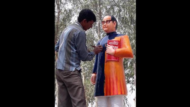 After facing flak over installing a saffron colour statue of Dalit icon BR Ambedkar, district authorities in Budayun, Uttar Pradesh changed its colour to blue. The saffron statue, unlike the usual blue, was installed in Dugraiyya village on Monday after the earlier one was vandalised on Saturday. (HT Photo) After facing flak over installing a saffron colour statue of Dalit icon BR Ambedkar, district authorities in Budayun, Uttar Pradesh changed its colour to blue. The saffron statue, unlike the usual blue, was installed in Dugraiyya village on Monday after the earlier one was vandalised on Saturday. (HT Photo)
