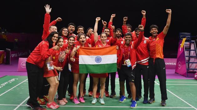 The Indian badminton team poses with the tricolour celebrating their mixed-team badminton final win at Commonwealth Games (CWG) 2018 in Gold Coast, Australia. Despite some good singles players, India had never won the team event at the Commonwealth Games. But on Monday, India set right that anomaly as the team defeated Malaysia 3-1 in the final to win gold. (Manvender Vashist / PTI)