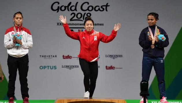 Gold medalist Chanu Saikhom (C), steps to the podium during the medal ceremony of women’s 48kg weightlifting event, on Thursday. Chanu was the first to secure a gold medal for India in this year’s games. (Manvender Vashist / PTI) Gold medalist Chanu Saikhom (C), steps to the podium during the medal ceremony of women’s 48kg weightlifting event, on Thursday. Chanu was the first to secure a gold medal for India in this year’s games. (Manvender Vashist / PTI)