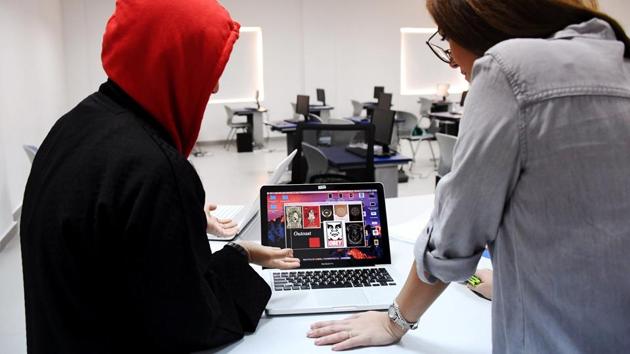 Al-Turkistani (R), a graphic design lecturer at Jeddah International College, critiques one of her students' work. “Jeddah today isn’t the same as Jeddah five, six years ago,” she said. “The scrutiny on clothes (has eased), there’s more places to go, working opportunities for women are the same as for men.” (Reem Baeshen / REUTERS) Al-Turkistani (R), a graphic design lecturer at Jeddah International College, critiques one of her students' work. “Jeddah today isn’t the same as Jeddah five, six years ago,” she said. “The scrutiny on clothes (has eased), there’s more places to go, working opportunities for women are the same as for men.” (Reem Baeshen / REUTERS)