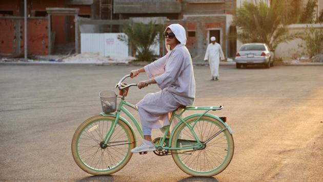 When Amirah al-Turkistani left Boston in 2015 after a graduate degree, friends mocked her decision to ship her beloved pistachio-coloured bicycle back home to Saudi Arabia. Riding in public was unthinkable then in the deeply conservative Muslim kingdom, where religious police patrolled public spaces to enforce modest dress, bans on music and alcohol, prayer-time store closures and the mixing of unrelated men and women. (Reem Baeshen / REUTERS) When Amirah al-Turkistani left Boston in 2015 after a graduate degree, friends mocked her decision to ship her beloved pistachio-coloured bicycle back home to Saudi Arabia. Riding in public was unthinkable then in the deeply conservative Muslim kingdom, where religious police patrolled public spaces to enforce modest dress, bans on music and alcohol, prayer-time store closures and the mixing of unrelated men and women. (Reem Baeshen / REUTERS)