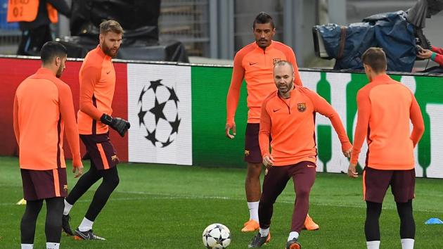 Barcelona's Andres Iniesta (2R) kicks a ball next to Barcelona's Brazilian midfielder Paulinho during a training session at the Olympic Stadium in Rome on the eve of the UEFA Champions League quarter final secondagainst AS Roma.(AFP)