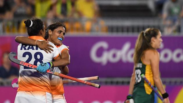 Rani of India (L) is congratulated by teammate Vandana Katariya after scoring a goal during the women's field hockey match between India and South Africa. India won the match 1-0. (AFP)