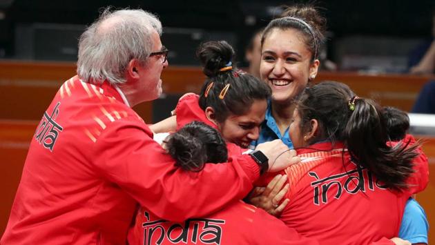 Members of India women’s table tennis team celebrate winning a gold medal at CWG 2018. Manika Batra was in superb form, registering two singles victories as India clinched an unlikely gold by beating a strong Singapore side 3-1 in the final at the Commonwealth Games here on Sunday. (Jeremy Lee / REUTERS) Members of India women’s table tennis team celebrate winning a gold medal at CWG 2018. Manika Batra was in superb form, registering two singles victories as India clinched an unlikely gold by beating a strong Singapore side 3-1 in the final at the Commonwealth Games here on Sunday. (Jeremy Lee / REUTERS)