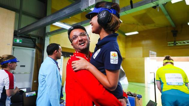 India's Heena Sidhu is hugged by her coach and husband Ronak Pandit following the women's 25m pistol shooting final. Sidhu won the gold by shattering a Games record. (AFP)