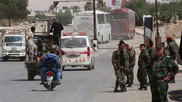 Pro-Syrian government forces gather around buses carrying Jaish al-Islam fighters and their families from their former rebel bastion of Douma. The evacuations came after accusations Syria's government had used toxic gas on Douma, which the regime denied. (AFP Photo) Pro-Syrian government forces gather around buses carrying Jaish al-Islam fighters and their families from their former rebel bastion of Douma. The evacuations came after accusations Syria's government had used toxic gas on Douma, which the regime denied. (AFP Photo)