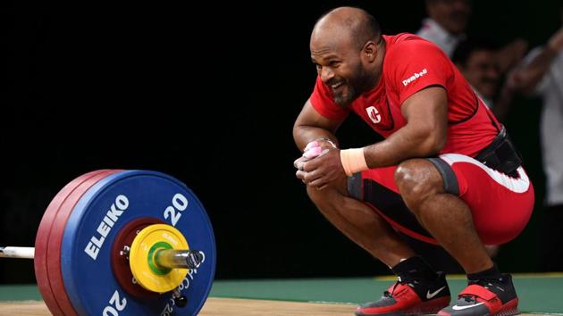 Sathish Kumar Sivalingam of India reacts after winning the gold medal in the men’s 77kg weightlifting event. Sathish continues in his father Sivalingam’s tradition, an ex-serviceman, who was also a medal winning weightlifter. (William West / AFP) Sathish Kumar Sivalingam of India reacts after winning the gold medal in the men’s 77kg weightlifting event. Sathish continues in his father Sivalingam’s tradition, an ex-serviceman, who was also a medal winning weightlifter. (William West / AFP)