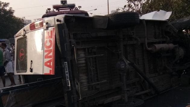 The ambulance toppled after hitting a divider. The ambulance toppled after hitting a divider.