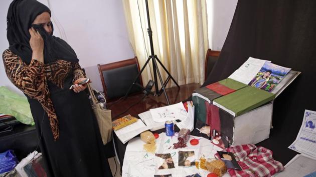 Adila Hamidi chokes back tears as she stands in front of mementos for her son Faisal’s "memory box". (AP) Adila Hamidi chokes back tears as she stands in front of mementos for her son Faisal’s "memory box". (AP)