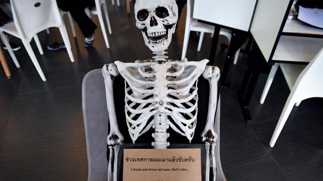 A skeleton on a chair warns against drinking and driving at the Kid Mai Death Awareness Cafe in Bangkok, Thailand. With drinks called ‘Death’ and ‘Painful’ on the menu and a skeleton splayed out in the corner, the meet-your-maker theme is alive and well at this open-air lunch spot in the Thai capital. (Lillian Suwanrumpha / AFP) A skeleton on a chair warns against drinking and driving at the Kid Mai Death Awareness Cafe in Bangkok, Thailand. With drinks called ‘Death’ and ‘Painful’ on the menu and a skeleton splayed out in the corner, the meet-your-maker theme is alive and well at this open-air lunch spot in the Thai capital. (Lillian Suwanrumpha / AFP)