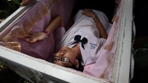 The centrepiece of the Kid Mai (Think New) Death Cafe experience though is a decorated white coffin where customers are encouraged to lay down for a few minutes to contemplate their final moments -- and secure a discount on their drink. (Lillian Suwanrumpha / AFP) The centrepiece of the Kid Mai (Think New) Death Cafe experience though is a decorated white coffin where customers are encouraged to lay down for a few minutes to contemplate their final moments -- and secure a discount on their drink. (Lillian Suwanrumpha / AFP)