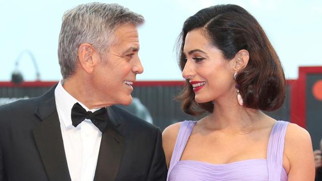George Clooney, left, and his wife Amal Clooney pose for photographers upon arrival at the premiere of the film Suburbicon during the 74th edition of the Venice Film Festival in Venice, Italy.(Joel Ryan/Invision/AP) George Clooney, left, and his wife Amal Clooney pose for photographers upon arrival at the premiere of the film Suburbicon during the 74th edition of the Venice Film Festival in Venice, Italy.(Joel Ryan/Invision/AP)