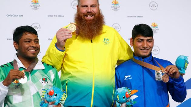Men's 50m Pistol gold medallist Daniel Repacholi (centre) of Australia flanked by silver medallist Shakil Ahmed of Bangladesh and bronze medallist Om Mitharval of India. (REUTERS)