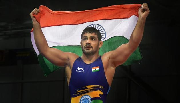 Sushil Kumar celebrates after winning gold in the men's freestyle 74kg wrestling category, beating Johannes Botha of South Africa in the final at the 2018 Commonwealth Games in Gold Coast on Thursday.(PTI)