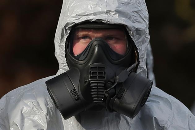 Members of the emergency services in protective coveralls and breathing equipment at the Salisbury District Hospital in Salisbury, southern England, on March 10, 2018.(AFP)